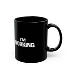 Black mug with 'I'm Working' text on a white background