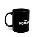 Black mug with 'I'm Working' text on a white background