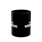 Black mug with 'I'm Working' text on a white background